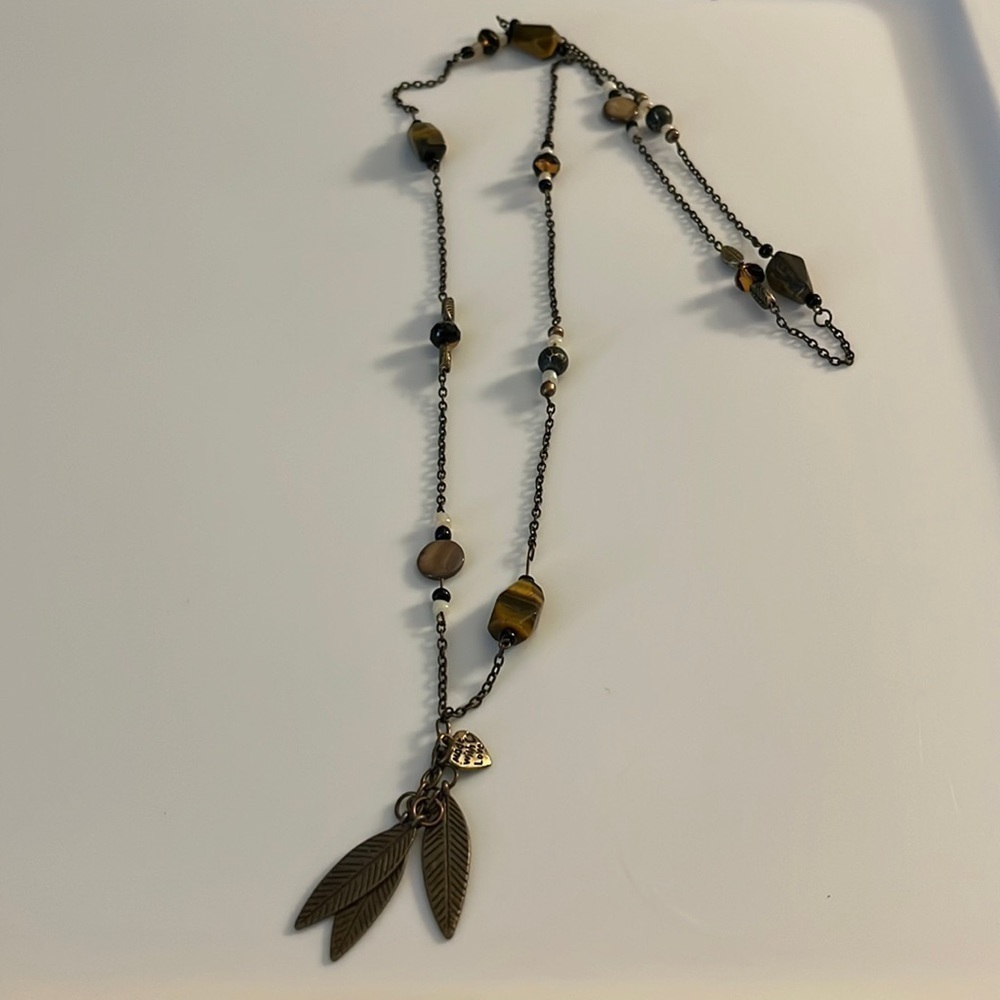 Made with Love feather long necklace. Gold feathers and brown colored beads.